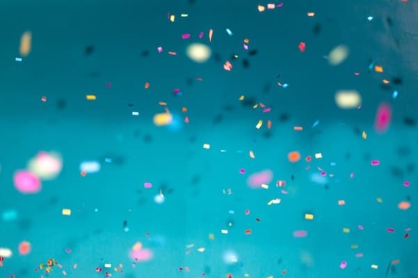 Image of party confetti with a blue backdrop